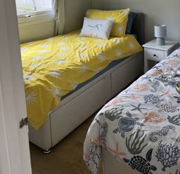 A bedroom with two beds and a nightstand at Chalet - Buckland 16, Bideford