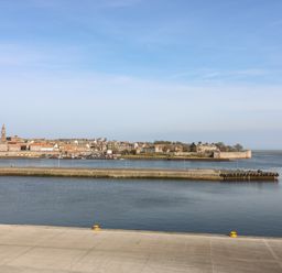 A view of water and buildings from a pier at Mill Wharf in Berwick-upon-Tweed