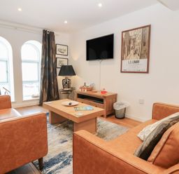 A living room with a sofa and television at Mill Wharf in Berwick-upon-Tweed