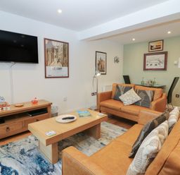 A living room with a television and sofa at Mill Wharf in Berwick-upon-Tweed