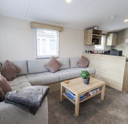 A living room with a sofa and coffee table at Hadrian's Rest in Wigton