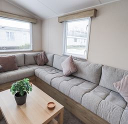 A living room with a sofa and table at Hadrian's Rest in Wigton