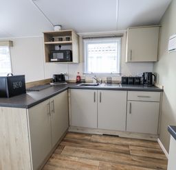 A kitchen with cabinets and appliances at Hadrian's Rest in Wigton