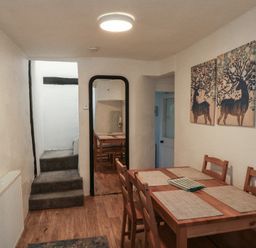 A dining room with a table and chairs at The Cottage in Budleigh Salterton