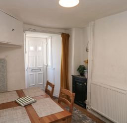 A dining room with a table and chairs at The Cottage in Budleigh Salterton