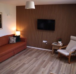 A living room with a sofa and television at Castle Rag in Parkend