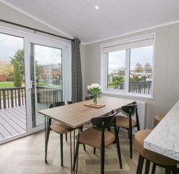 A dining room with a table and chairs at Tulip in Eardisland