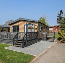 A house with a deck and planters at Tulip in Eardisland