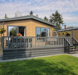 A house with a deck and flower pots at Poppy in Eardisland