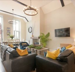 A living room with a sofa and television at Juniper Cottage in 