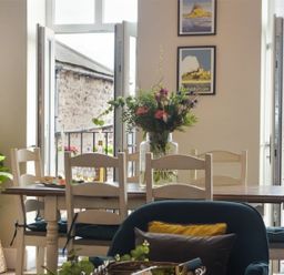 A dining room with a table and chairs at Juniper Cottage