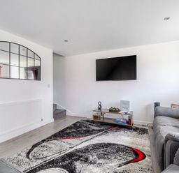 A living room with a sofa and television at Ruby Red Near Brigg