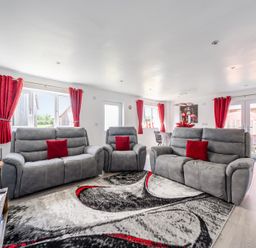 A living room with sofas and large windows at Ruby Red near Brigg
