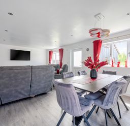 A living room with a sofa and dining table at Ruby Red near Brigg