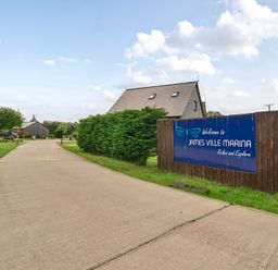 A pathway leading to buildings at James Ville Marina near Brigg