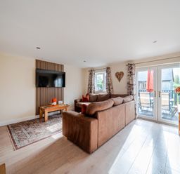 A living room with a sofa and television at Lodge 25 - Pumpkin Near Brigg