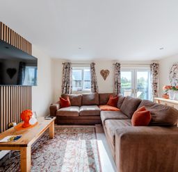 A living room with a sofa and television at Lodge 25 - Pumpkin near Brigg