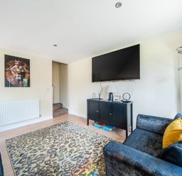 A living room with a TV and couches at Poker Lodge near Brigg