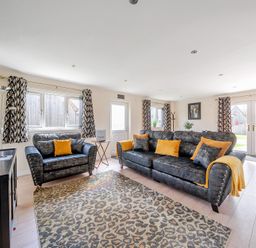A living room with a sofa and television at Poker Lodge Near Brigg