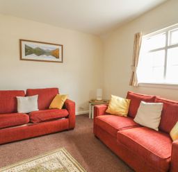 A living room with two sofas and a window at Cottage No 9 in Keswick