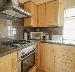A kitchen with a stove and microwave at Cottage No 9 in Keswick