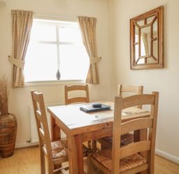 A dining room with a table and chairs at Cottage No 9 in Keswick