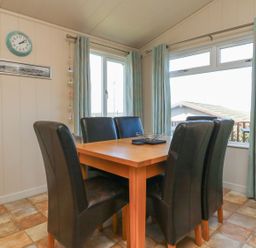 A dining room with a table and chairs at 1 Ocean Terrace in Ilfracombe