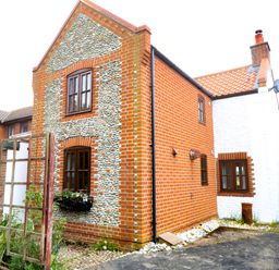 A house with a brick exterior and windows at Mabby in Great Yarmouth