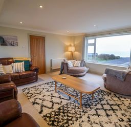 A living room with sofas and a coffee table at Cliff Cottage