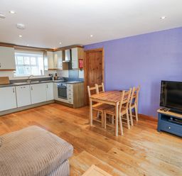 A kitchen with a dining table and chairs at Swallows Rest in Hexham