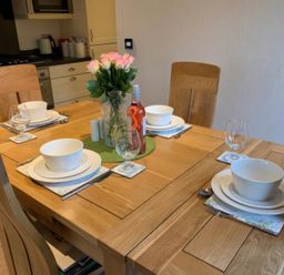 A dining table set with plates and glasses at Tiggywinkle Beck - White Cross Bay, Windermere