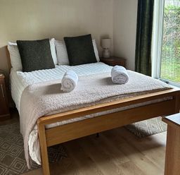 A bedroom with a bed and bedside table at Tiggywinkle Beck - White Cross Bay Windermere