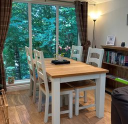 A dining room with a table and chairs at Owls House - White Cross Bay Windermere