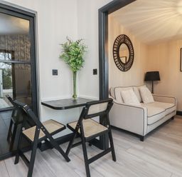 A living room with a sofa and a small table at Caban Tan Y Ffawydd in Chwilog near Y Ffor