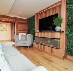 A living room with a sofa and armchair at Riverside Lodge in Afonwen