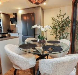 A dining room with a glass table and chairs at Riverside Lodge in Afonwen