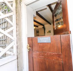 An entrance door with a sign at Englewood Cottage in Hexham