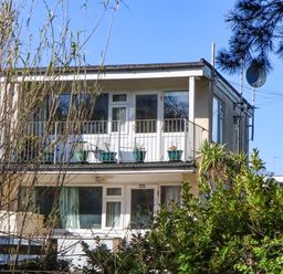 A building with balcony and plants at Flat 1 Lee Cliff Park Dawlish Warren