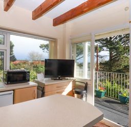 A kitchen with a refrigerator and microwave at Flat 1 Lee Cliff Park, Dawlish Warren