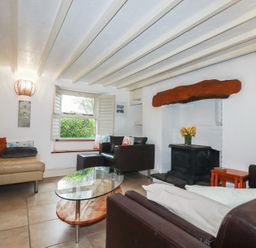A living room with a coffee table and sofas at Plenteth in Truro