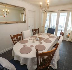 A dining room with a table and chairs at 16 Forth An Nance in Portreath