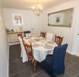 A dining room with a table and chairs at 16 Forth An Nance, Portreath