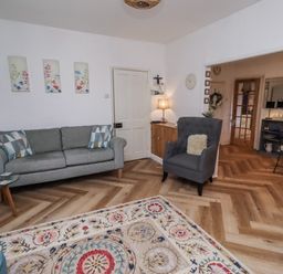 A living room with a sofa and armchair at 55 Meldon terrace Newbiggin-by-the-Sea