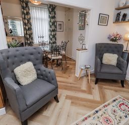 A living room with seating and dining area at 55 Meldon terrace Newbiggin-by-the-Sea
