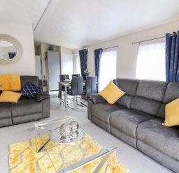 A living room with a coffee table and seating area at 33 Woodpecker Lodge in Llanarth
