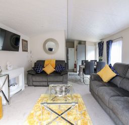A living room with sofas and a television at 33 Woodpecker Lodge Llanarth