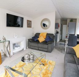 A living room with a sofa and coffee table at 33 Woodpecker Lodge in Llanarth