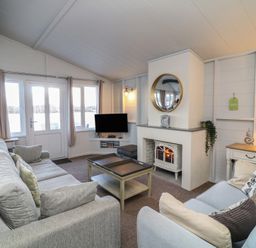 A living room with a coffee table and television at Fairways 22 in Lincoln