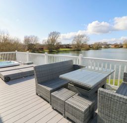 A deck with outdoor furniture and a hot tub at Fairways 22 in Tattershall