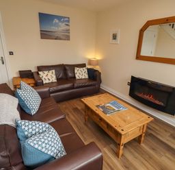 A living room with a sofa and coffee table at 35 Longbeach Drive